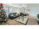 Living room with leather furniture, a coffee table, and a Christmas tree at 25763 W Satellite Ln, Buckeye, AZ 85326