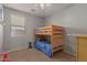 Bedroom with bunk beds, window, and dresser at 2833 S 88Th Ln, Tolleson, AZ 85353