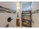 Walk-in shower with tiled walls, built-in shelving and grab bar at 4380 W Ruby Dr, Eloy, AZ 85131