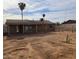 Backyard view of house with covered patio and large empty yard at 5936 W Berkeley Rd, Phoenix, AZ 85035