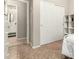 Bedroom with double closet doors, tiled flooring, and view of an ensuite bathroom at 6219 S 30Th Dr, Phoenix, AZ 85041