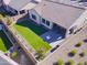 Artificial turf backyard with patio and covered seating area at 6364 W Springfield Way, Florence, AZ 85132