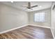 Spacious bedroom with wood-look floors and a ceiling fan at 6746 W Holly St, Phoenix, AZ 85035