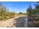 A pathway winds through the desert landscape leading to the home at 7262 E Lower Wash Pass, Scottsdale, AZ 85266