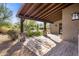 Covered patio with stone pillars and wood beams overlooks the backyard at 7262 E Lower Wash Pass, Scottsdale, AZ 85266