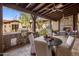 Outdoor patio features a stone fireplace, comfortable seating, and a dining area at 7262 E Lower Wash Pass, Scottsdale, AZ 85266