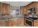 Updated kitchen featuring wood cabinets and granite countertops at 848 S Revolta Cir, Mesa, AZ 85208