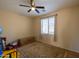 Cozy bedroom with carpeted floor, window with blinds and ceiling fan at 964 E Ranch Rd, Gilbert, AZ 85296