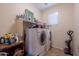 Laundry room with washer, dryer, and storage at 964 E Ranch Rd, Gilbert, AZ 85296