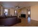 Living room with a brown sectional sofa and tile floors at 964 E Ranch Rd, Gilbert, AZ 85296