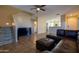 Living area with a sectional sofa, stairs, and views into the kitchen at 964 E Ranch Rd, Gilbert, AZ 85296