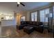 Spacious living room featuring a brown leather sectional sofa and ottoman at 964 E Ranch Rd, Gilbert, AZ 85296