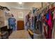 Large walk-in closet with shelving and hanging rods at 964 E Ranch Rd, Gilbert, AZ 85296