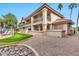 Exterior view of the building with a pool and landscaping at 9711 E Mountain View Rd # 1516, Scottsdale, AZ 85258