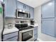 Modern kitchen featuring stainless steel appliances and light blue cabinets at 9711 E Mountain View Rd # 1516, Scottsdale, AZ 85258