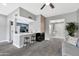 Open living room with kitchen, fireplace, and patio access at 9711 E Mountain View Rd # 1516, Scottsdale, AZ 85258