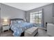 Main bedroom with a king bed, light gray walls and a window at 9711 E Mountain View Rd # 1516, Scottsdale, AZ 85258