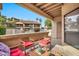 Covered patio with seating and view of the community pool at 9711 E Mountain View Rd # 1516, Scottsdale, AZ 85258