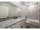 Clean bathroom with granite countertop, white cabinets and bathtub at 10359 N 115Th Ave, Youngtown, AZ 85363