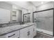 Modern bathroom with granite countertop, white cabinets, and glass shower at 10359 N 115Th Ave, Youngtown, AZ 85363