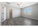 Bright bedroom with wood-look floors and window with blinds at 10359 N 115Th Ave, Youngtown, AZ 85363