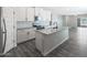 Modern kitchen with white shaker cabinets, granite island and stainless steel appliances at 10359 N 115Th Ave, Youngtown, AZ 85363