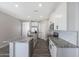Modern kitchen with white shaker cabinets, granite island and stainless steel appliances at 10359 N 115Th Ave, Youngtown, AZ 85363