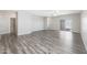 Spacious living room with grey wood-look flooring and sliding glass doors at 10359 N 115Th Ave, Youngtown, AZ 85363