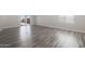 Bright living room featuring wood-look floors and sliding glass door to backyard at 10359 N 115Th Ave, Youngtown, AZ 85363