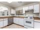 Bright kitchen featuring white cabinets, gas range, and dishwasher at 10514 W Donald Dr, Peoria, AZ 85383