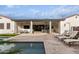 Stunning backyard oasis with a covered patio, pool, and lounge chairs at 10986 N Northfield St, Surprise, AZ 85388