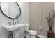 Stylish powder room with pedestal sink and patterned wallpaper at 10986 N Northfield St, Surprise, AZ 85388