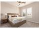 Spacious bedroom with plush bed, wooden frame, and large windows at 10986 N Northfield St, Surprise, AZ 85388