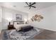Main bedroom with king bed, wood accents, and blue rug at 10986 N Northfield St, Surprise, AZ 85388