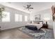 Spacious bedroom with a king-size bed and blue bench at 10986 N Northfield St, Surprise, AZ 85388