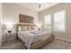 Bright bedroom with a queen-size bed and wood frame at 10986 N Northfield St, Surprise, AZ 85388