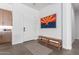 Bright and airy entryway with a wooden bench and Arizona flag at 10986 N Northfield St, Surprise, AZ 85388
