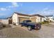 View of the house from the side showcasing the garage and landscaping at 10986 N Northfield St, Surprise, AZ 85388