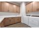 Functional laundry room with washer, dryer, and ample cabinetry at 10986 N Northfield St, Surprise, AZ 85388
