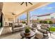 Relaxing covered patio with seating area and view of the pool at 10986 N Northfield St, Surprise, AZ 85388