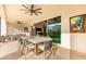 Outdoor patio with dining table and seating area, adjacent to the house at 10986 N Northfield St, Surprise, AZ 85388