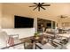 Covered patio with comfortable seating, large TV, and ceiling fans at 10986 N Northfield St, Surprise, AZ 85388