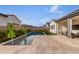 Long, rectangular pool surrounded by a spacious patio and landscaping at 10986 N Northfield St, Surprise, AZ 85388