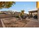 Large backyard with patio, seating area, and grassy area at 11867 W Grant St, Avondale, AZ 85323