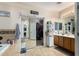 Bathroom with a large mirror, double sinks and a bathtub at 11867 W Grant St, Avondale, AZ 85323