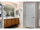Bathroom with double sinks and wood cabinets at 11867 W Grant St, Avondale, AZ 85323