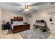 Bright bedroom with wood bed frame and carpeted floor at 11867 W Grant St, Avondale, AZ 85323