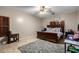 Spacious bedroom with wood bed frame and carpeted floor at 11867 W Grant St, Avondale, AZ 85323