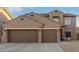 Two-story house with three car garage and desert landscaping at 11867 W Grant St, Avondale, AZ 85323