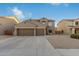 Two-story house with three car garage and desert landscaping at 11867 W Grant St, Avondale, AZ 85323